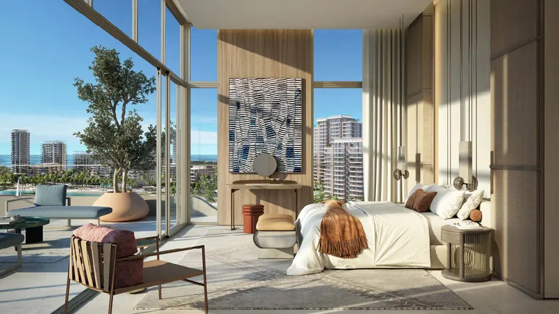 Bedroom at Bay Grove Residences with full-height glazing and a terrace overlooking the water