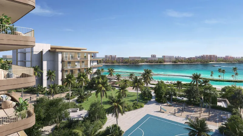 View from a curved balcony over the podium gardens, pool and beach at Bay Grove Residences