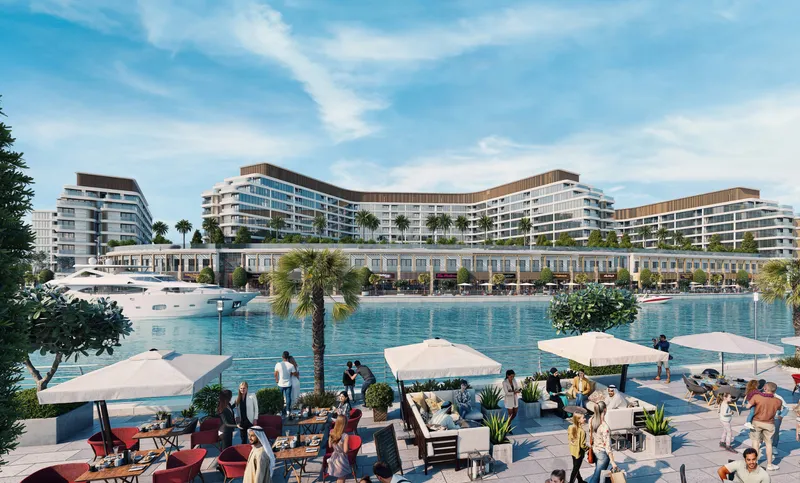 Bayfront Marina Residences seen across the water from a café terrace on the marina promenade