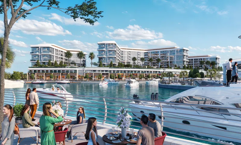 Marina Residences seen across the water from a waterside dining terrace on Sobha Siniya Island