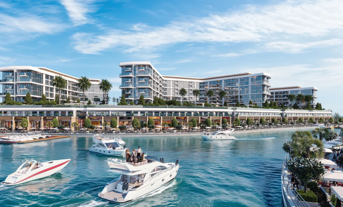 Marina Residences buildings seen across the water on Sobha Siniya Island, with yachts in the foreground