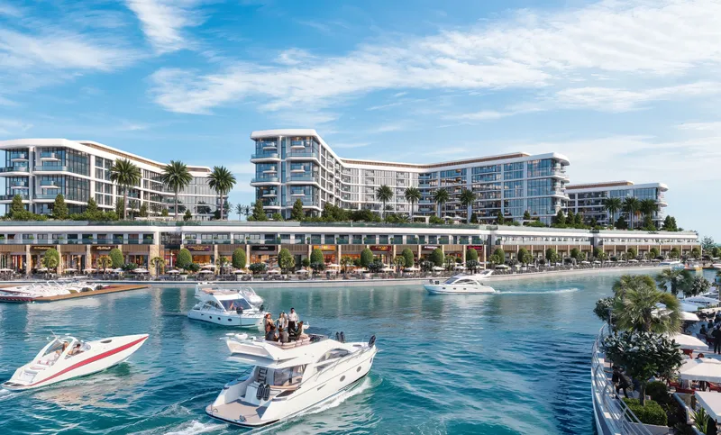 Marina Residences buildings seen across the water on Sobha Siniya Island, with yachts in the foreground