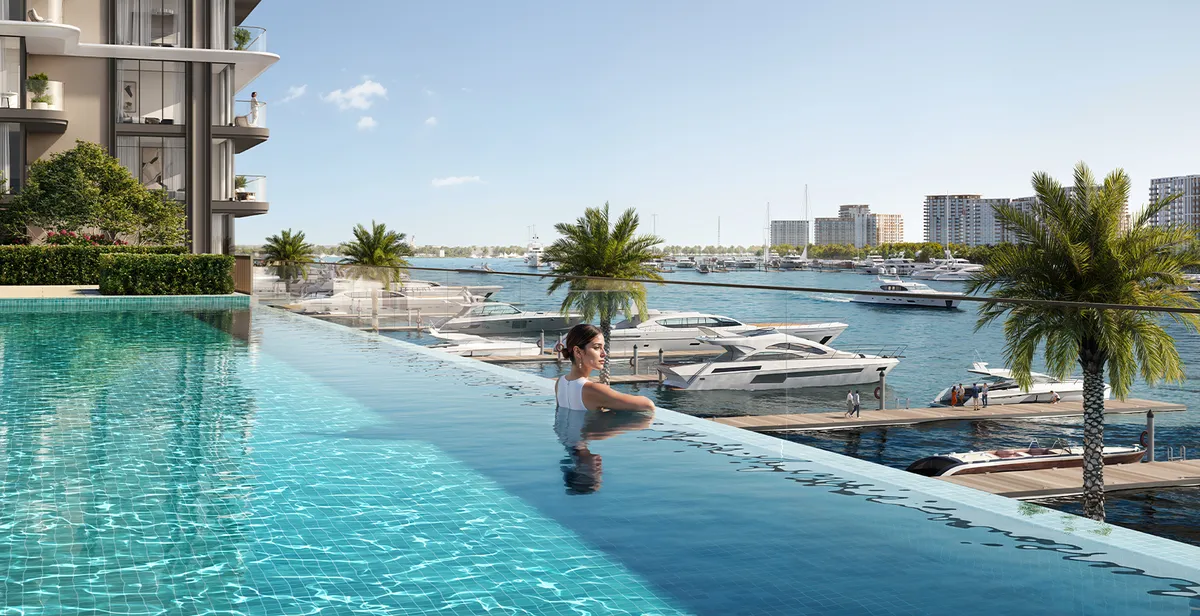 Render of the Baystar by Vida infinity pool with the tower behind and yachts berthed in the marina
