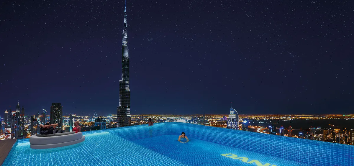 Infinity pool at Bayz 101 by Danube at night with Burj Khalifa on the skyline