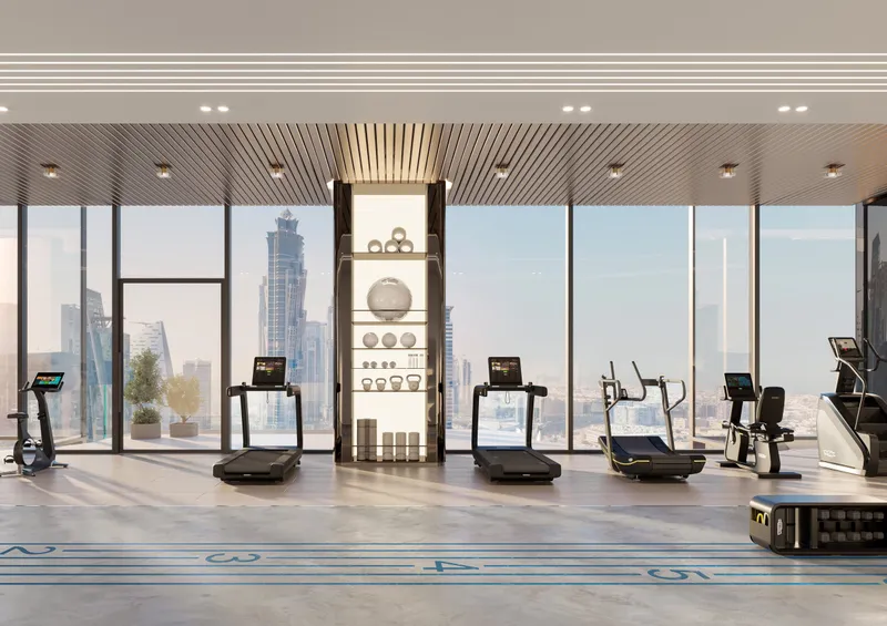 Render of the fitness studio at Berkeley Tower with training equipment and floor-to-ceiling glass