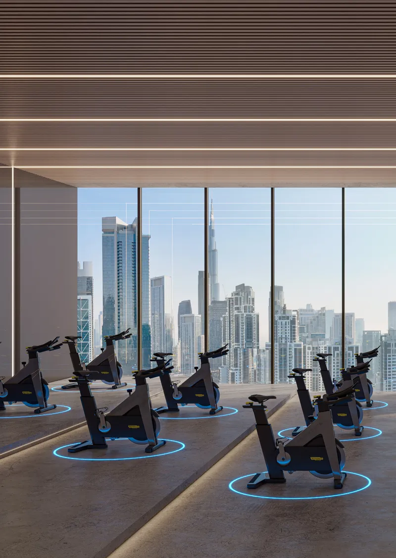 Render of the spinning studio at Berkeley Tower with rows of bikes facing floor-to-ceiling windows over the Dubai skyline