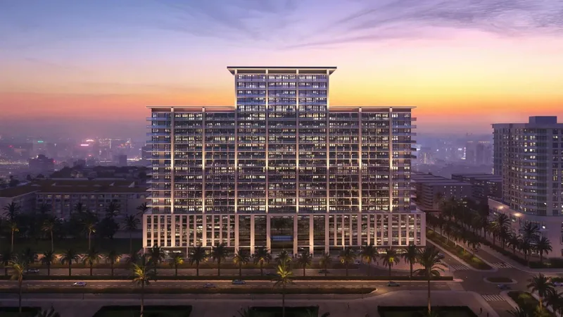 Computer-generated render of the Binghatti Amberhall building in Jumeirah Village Circle lit at dusk