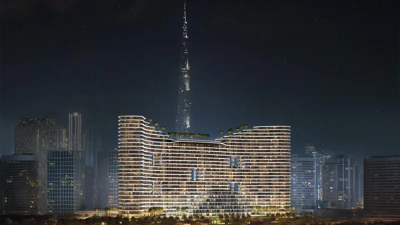 Render of Binghatti Aquarise lit at night with the Burj Khalifa behind