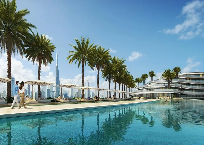 Render of the Binghatti Aquarise pool deck with palms, loungers and a view of the Burj Khalifa