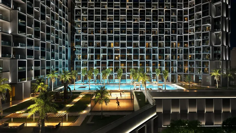 Render of the Binghatti Cullinan pool deck lit at night beneath the gridded façade