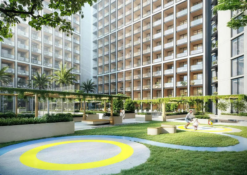Render of the children's play area and shaded seating between the Binghatti Elite towers