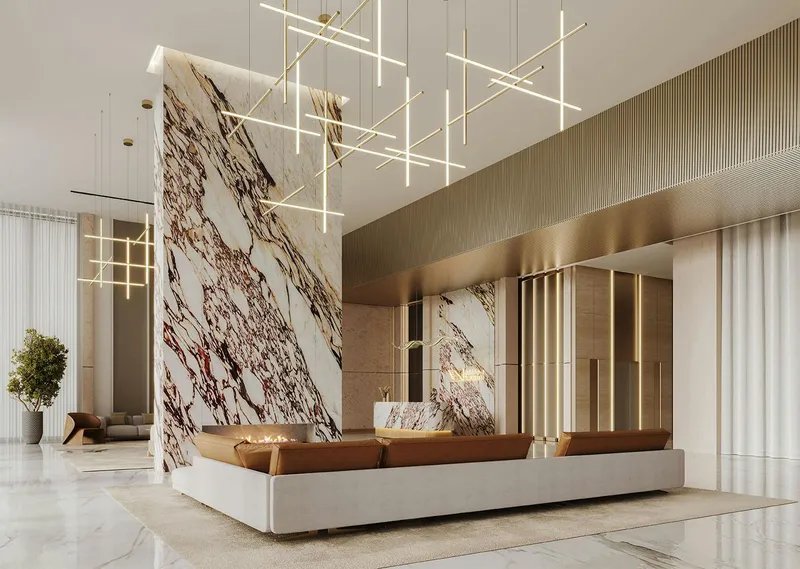 Render of the double-height lobby at Binghatti Ghost with a veined marble wall and linear pendant lights
