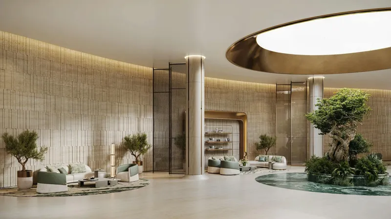 Render of the Binghatti Hillcrest lobby with stone walls, lounge seating and an indoor tree