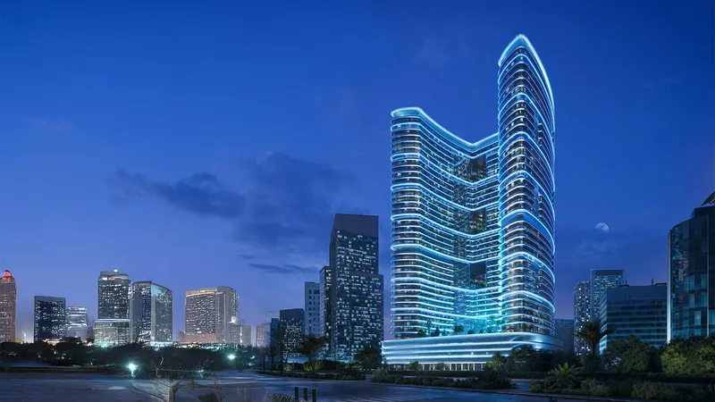 Render of the curved Binghatti Hillviews tower lit at night