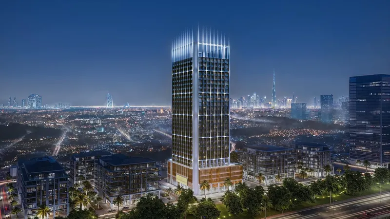 Aerial render of the Binghatti Luxuria tower at dusk above the low-rise streets of Jumeirah Village Triangle, with the Dubai skyline on the horizon