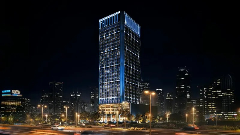 Render of the Binghatti Luxuria tower lit at night above its podium