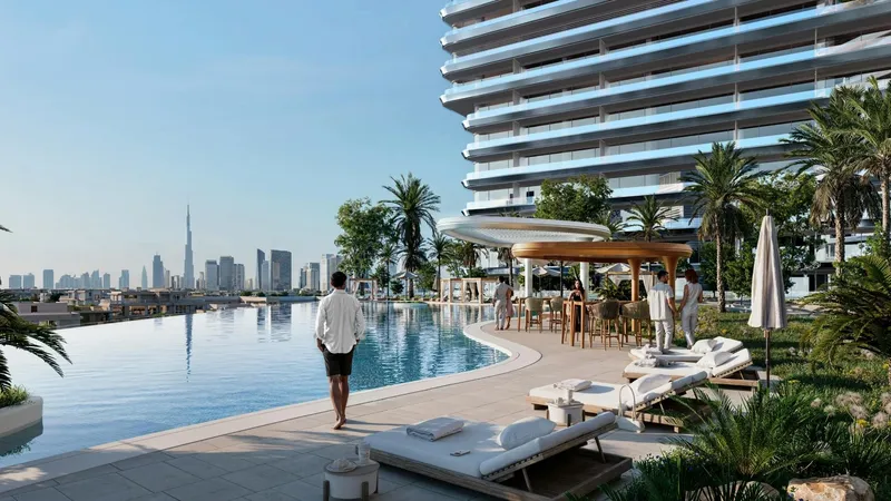 Render of the pool deck at Binghatti Sky Terraces with loungers, a shaded pavilion and the Dubai skyline in the distance