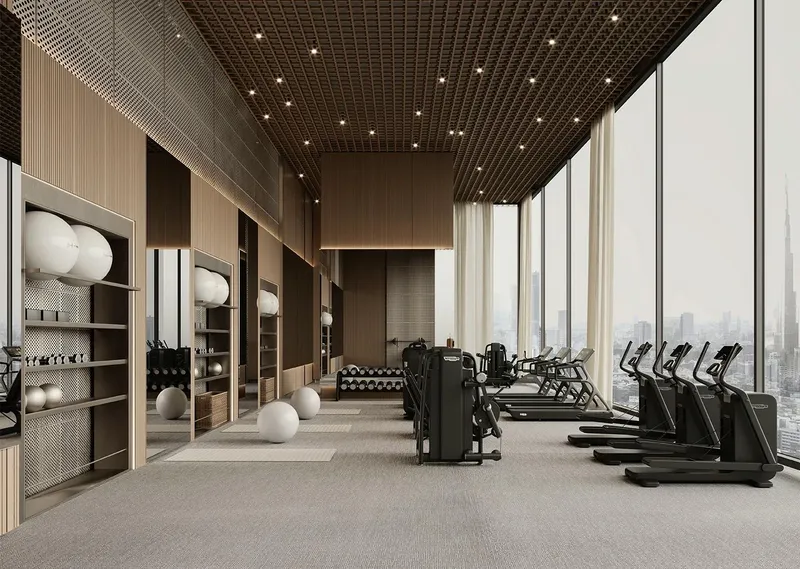 Render of the Binghatti Skyhall gym with cardio machines facing floor-to-ceiling windows