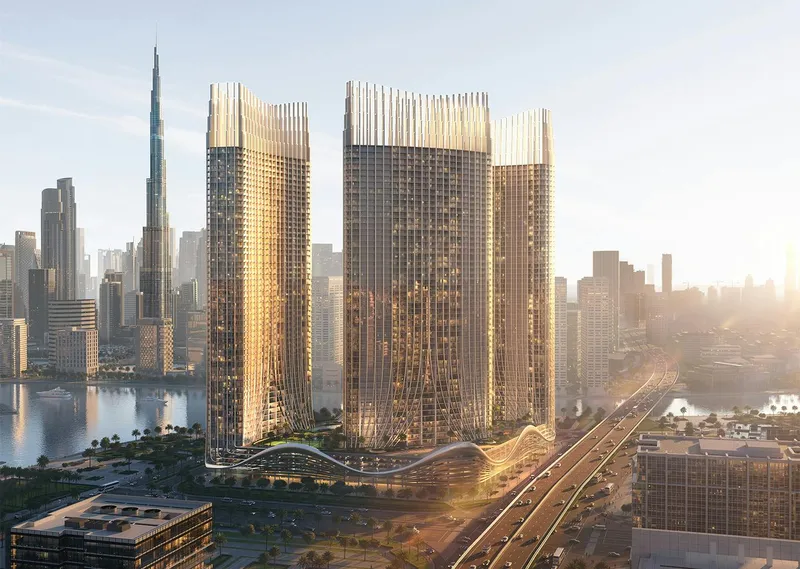 Render of the Binghatti Skyrise towers in morning light with the Burj Khalifa behind