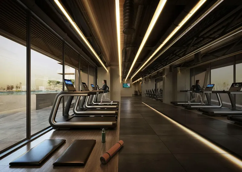 Render of the gym at Binghatti Starlight with treadmills facing floor-to-ceiling windows