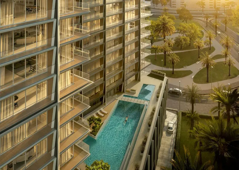 Render from above of the podium swimming pool at Binghatti Starlight, with landscaped grounds beyond