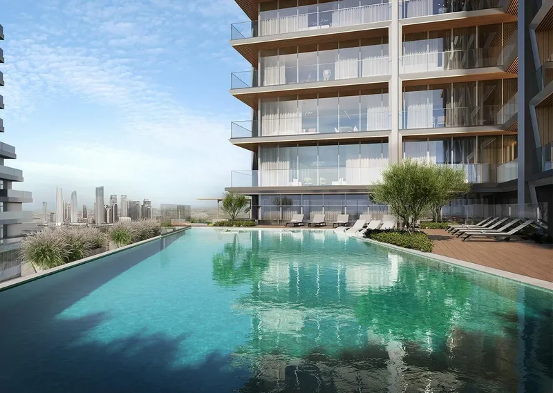 Render of the swimming pool and sun loungers at Binghatti Starlight with the city skyline in the distance