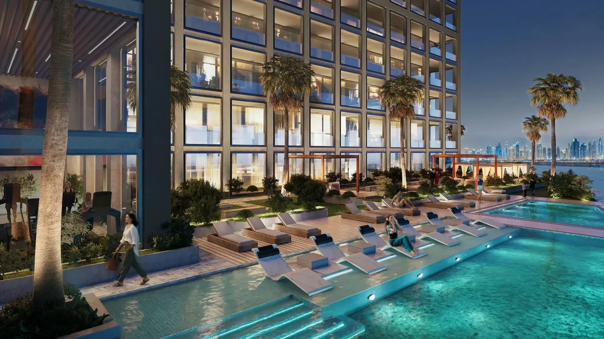 Render of the Binghatti Titania pool with in-water loungers in the evening