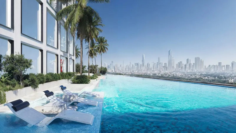 Render of the Binghatti Titania pool edge with loungers and a view to the Dubai skyline