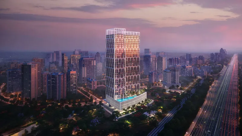 Computer-generated aerial render of the Binghatti Titania tower in Majan at dusk, beside Sheikh Mohammed Bin Zayed Road