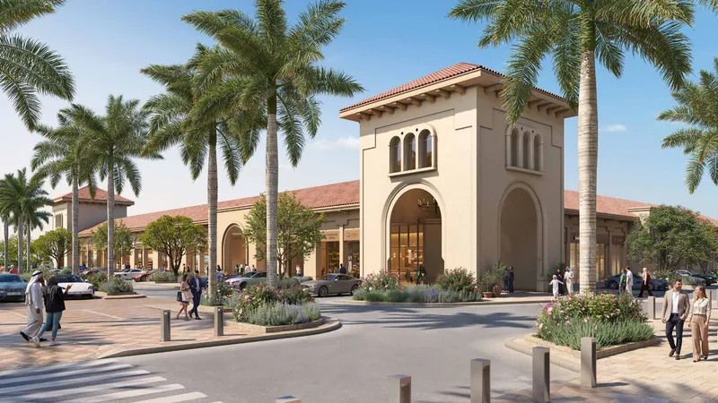 Street view of the Souk Alhambra entrance with palm trees