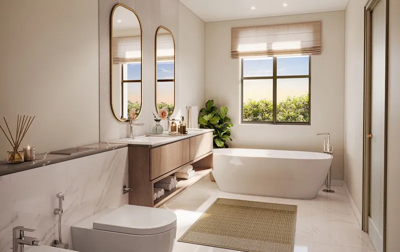 Bathroom in a Marbella villa with a freestanding bath and twin arched mirrors