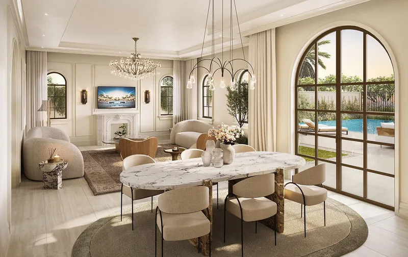 Living and dining room of a Marbella villa with arched windows opening to a pool