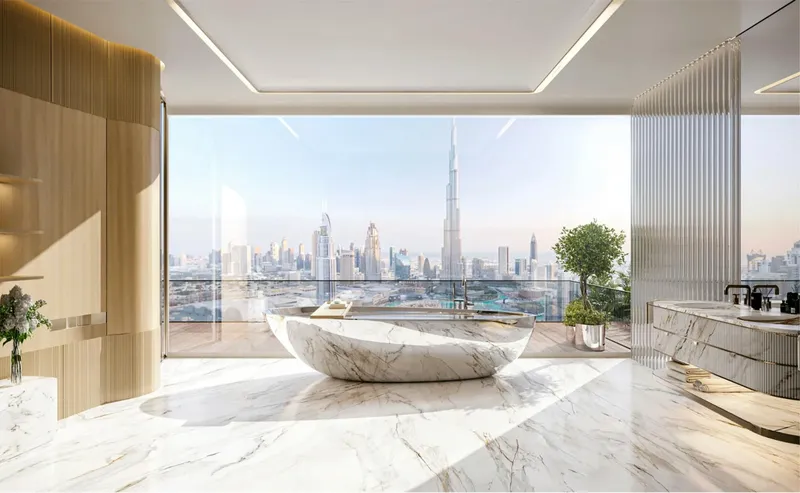 Render of a bathroom with a freestanding marble bath facing the Downtown Dubai skyline at Bugatti Residences by Binghatti