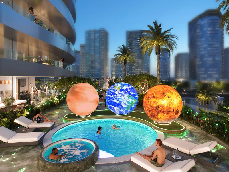 Pool at Canal Crown with illuminated planet sculptures and the Business Bay skyline behind