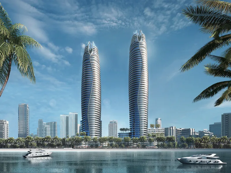 The Canal Crown towers by DAMAC rising beside the Dubai Canal, seen from the water