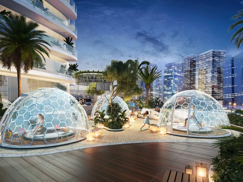 Glass yoga domes on a landscaped terrace at Canal Heights in the evening