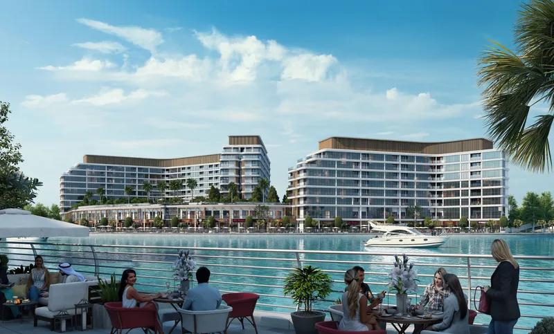 Canalside Marina Residences seen across the canal from a waterside dining terrace