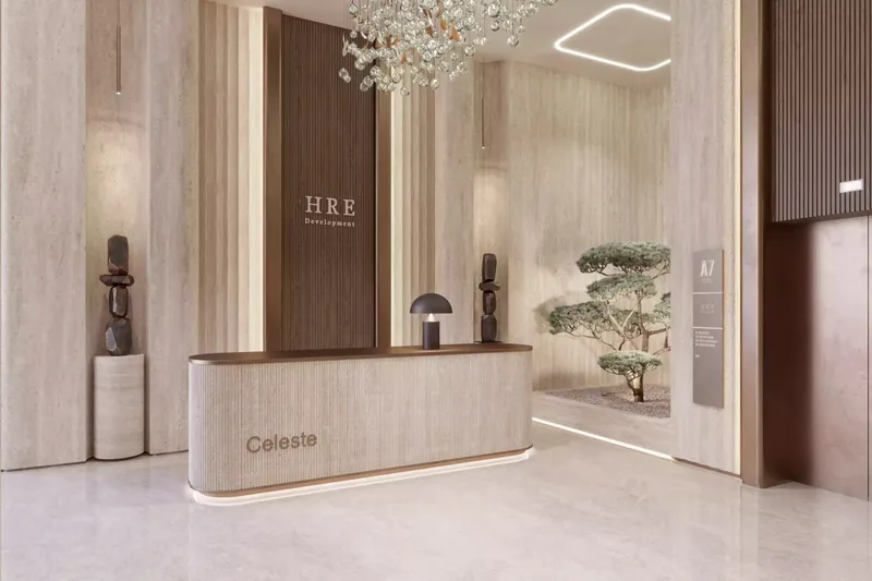 Lobby of Celeste with a curved reception desk, timber wall panels and a chandelier