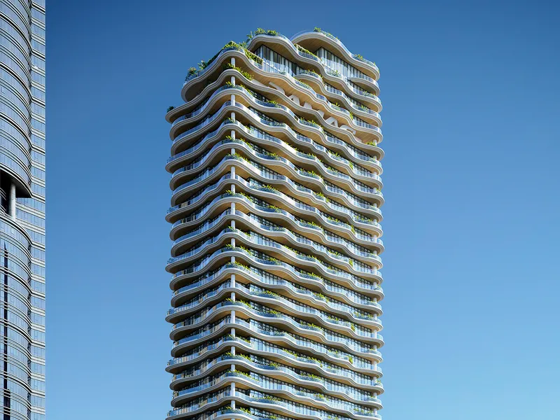 Upper floors of Chic Tower with undulating planted terraces against a clear sky