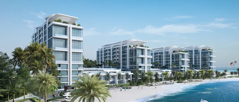 The four buildings of Coastline Beach Residences behind the beach on Sobha Siniya Island