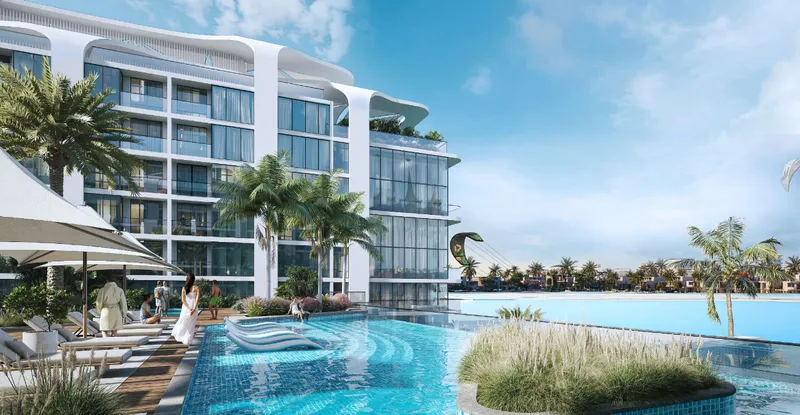 Swimming pool and sun deck beside a building at Coastline Beach Residences, with the lagoon beyond