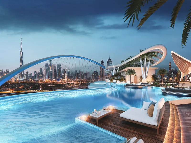 Podium lagoon at Couture by Cavalli at night, looking towards the Tolerance Bridge and the Downtown Dubai skyline