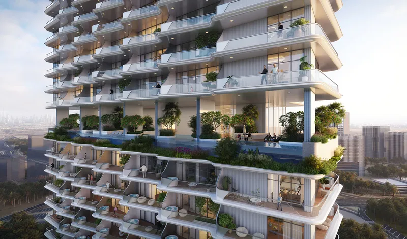 Curved white balconies and a planted sky terrace on the facade of Cove by Imtiaz