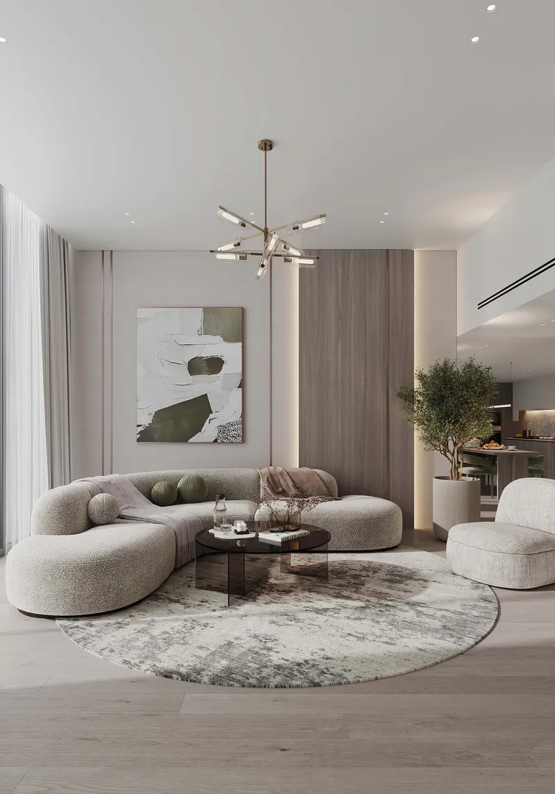 Furnished living room with a curved sofa and open kitchen at Cove by Imtiaz