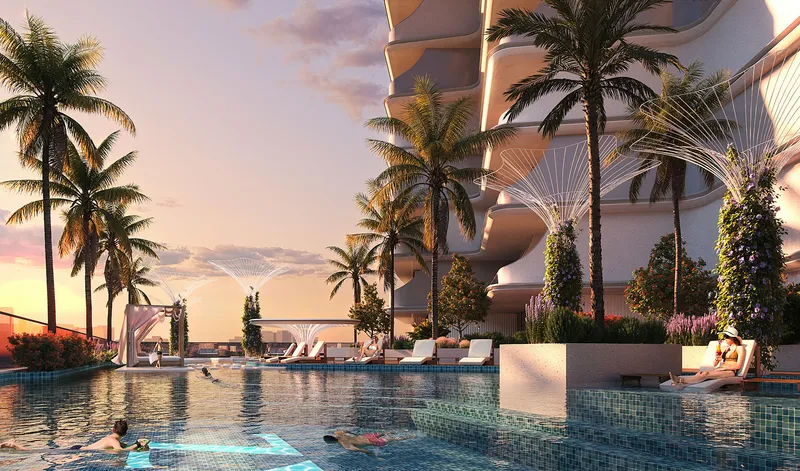 Podium swimming pool with sun loungers and palms at Cove by Imtiaz at sunset