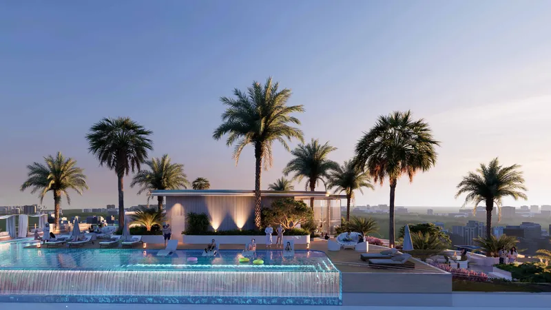 Rooftop infinity pool with palms and sun loungers at Cove Grand by Imtiaz at dusk