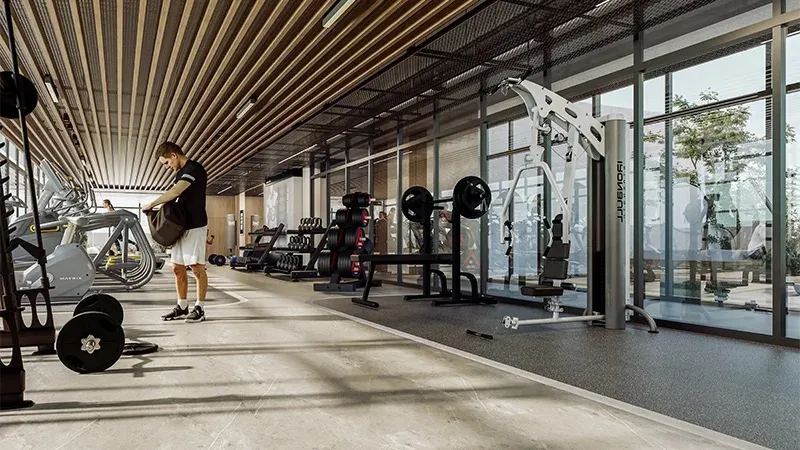 Gym with weight machines and floor-to-ceiling glazing at Coventry 49