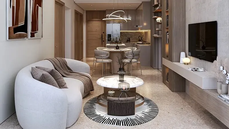 Living room with a curved sofa, round coffee table and open kitchen beyond in a Coventry 66 apartment