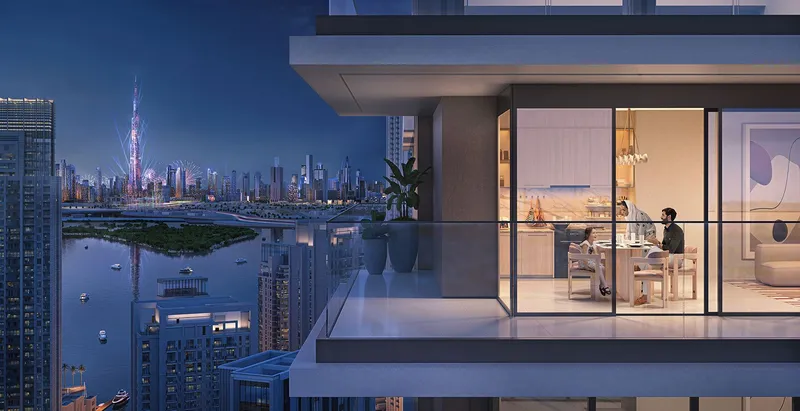 Render of a Creek Waters 2 balcony at night with the creek and the Downtown Dubai skyline beyond