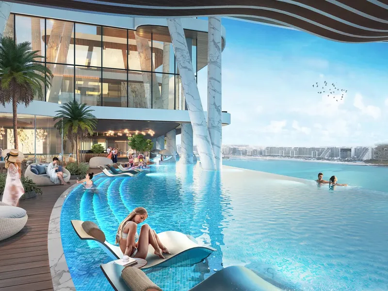 Infinity pool at DAMAC Bay 2 by Cavalli with loungers and a sea view